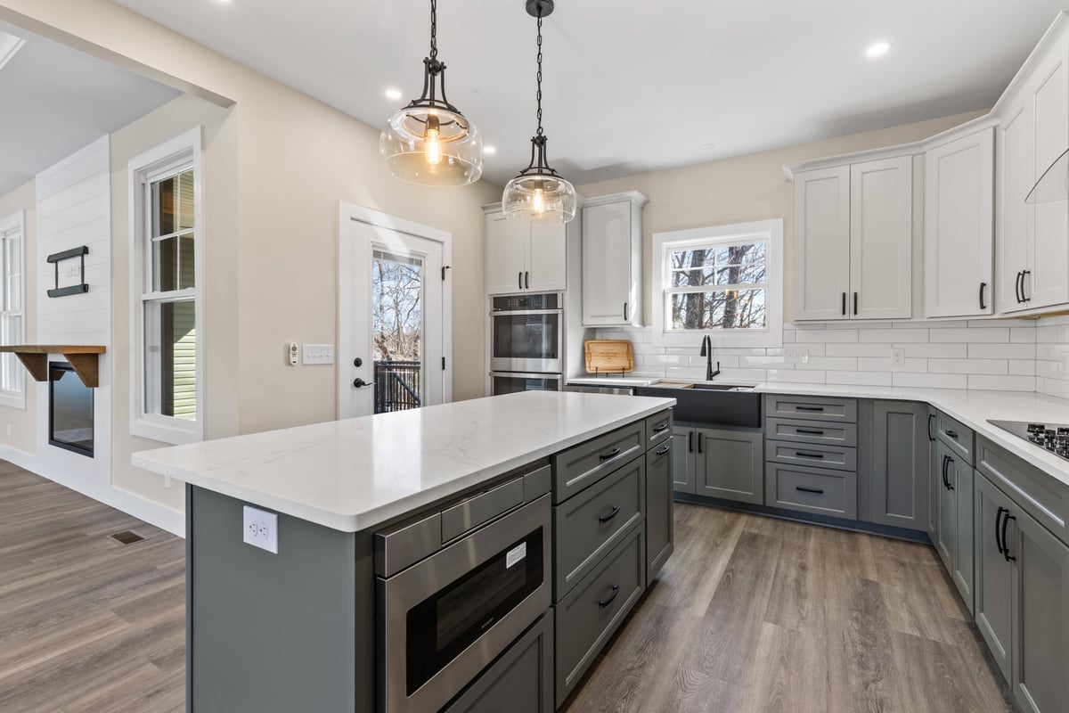 Close-up view of the elegant kitchen island and lighting in a custom home in Knoxville, TN by Debuty Builders, Inc.