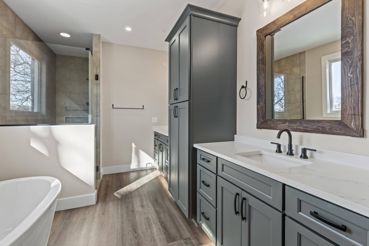 Luxurious master bathroom with dual vanities, a freestanding tub, and a walk-in shower in a custom home in Knoxville, TN by Debuty Builders, Inc.