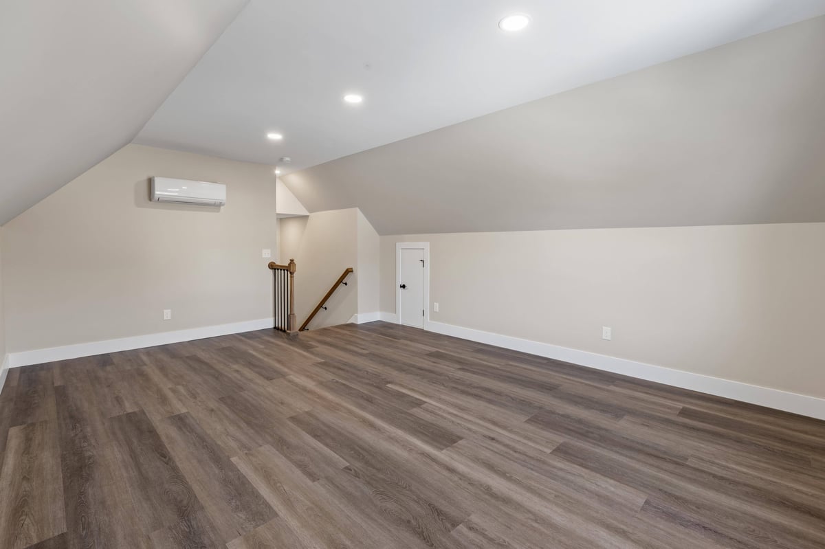 Open loft area with hardwood floors, recessed lighting, and ample space in a custom home in Knoxville, TN by Debuty Builders, Inc.