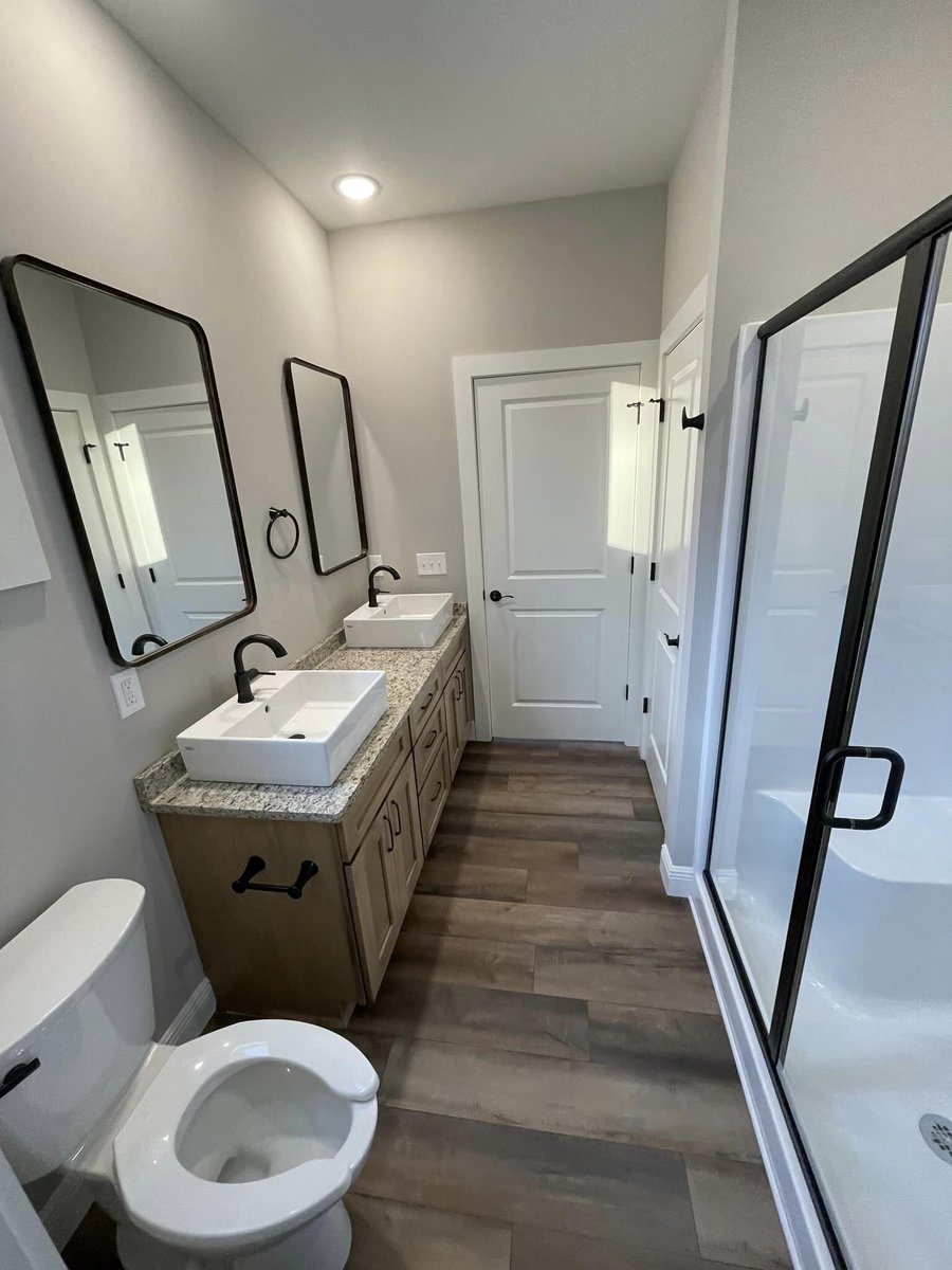 Bathroom with dual sinks and walk-in shower in custom home by Debuty Builders, Knoxville, TN