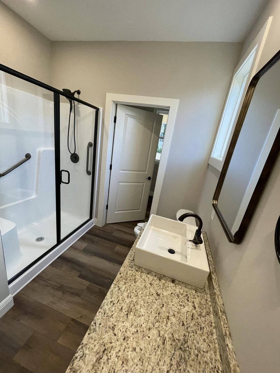 Bathroom with granite countertop and walk-in shower in custom home by Debuty Builders, Knoxville, TN