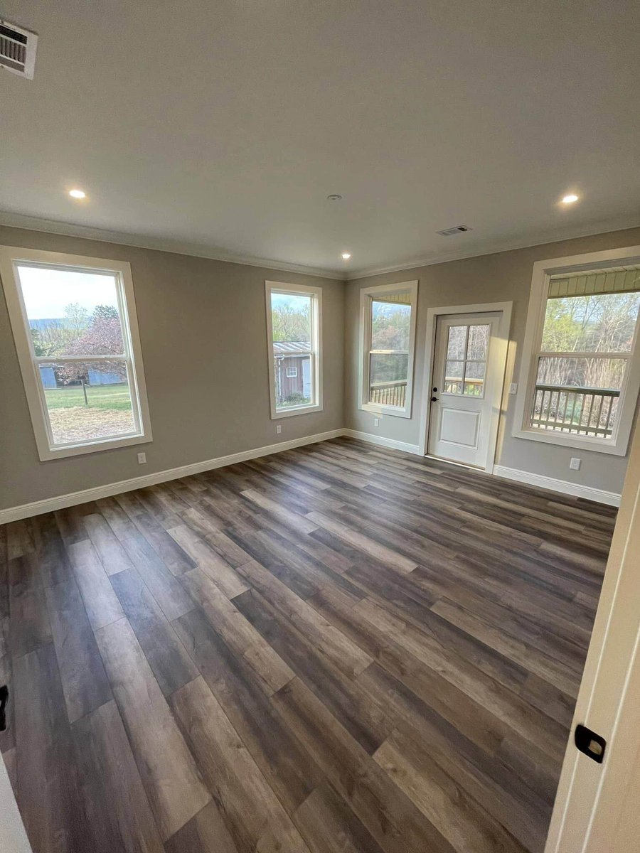 Bright living room with large windows in custom home by Debuty Builders, Knoxville, TN
