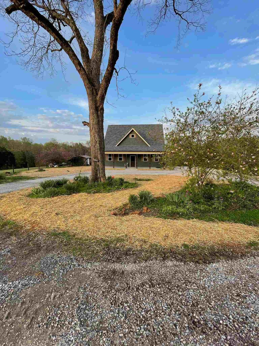 Front yard view of custom-built home with large tree by Debuty Builders in Knoxville, TN