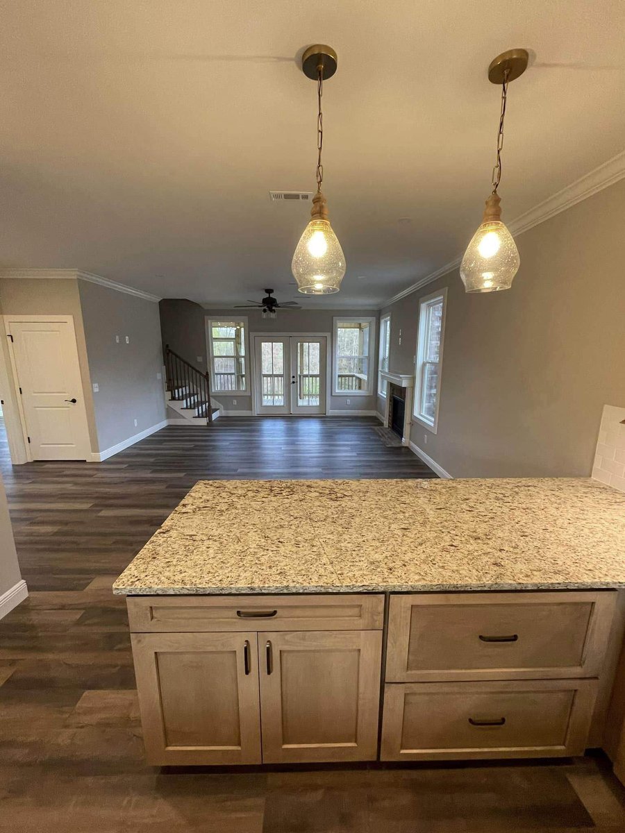 Granite kitchen island overlooking living room in custom home by Debuty Builders, Knoxville, TN