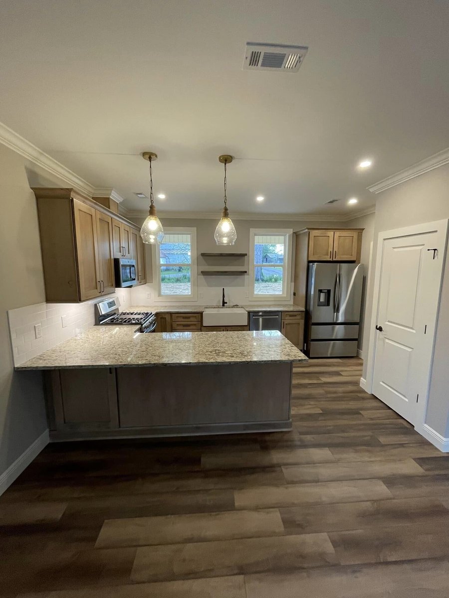 Kitchen with farmhouse sink and stainless steel appliances in custom home by Debuty Builders, Knoxville, TN