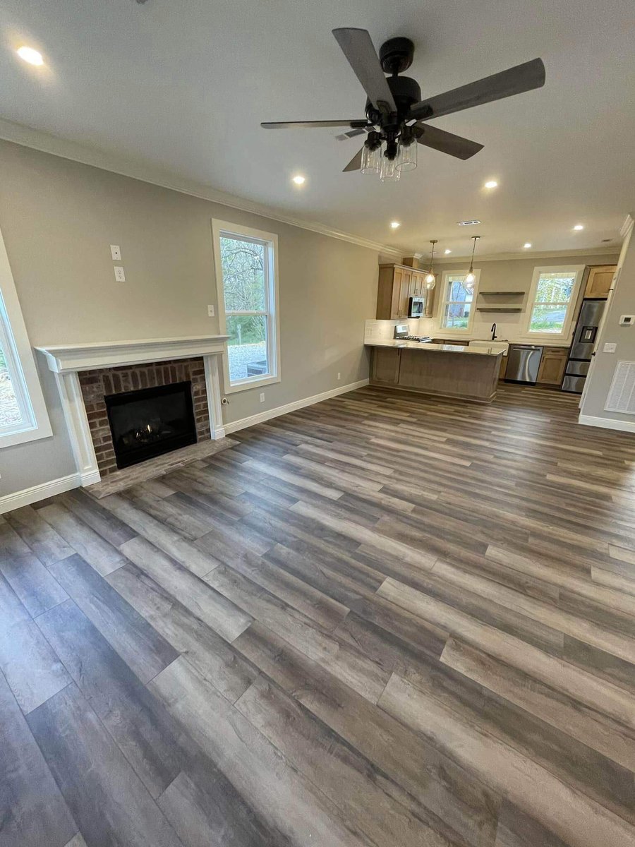 Living room with fireplace and ceiling fan in custom home by Debuty Builders, Knoxville, TN