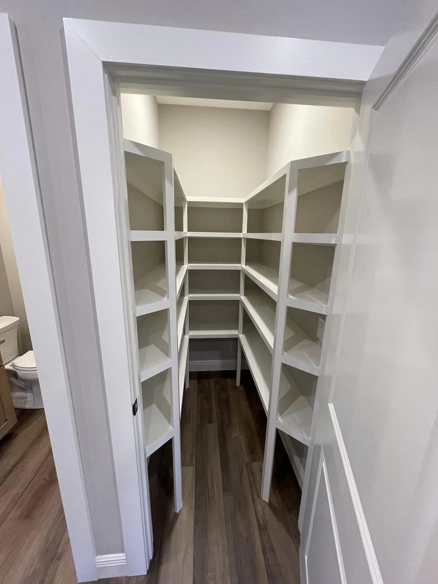 Walk-in pantry with white shelving in custom home by Debuty Builders, Knoxville, TN
