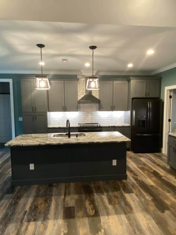 Modern kitchen with gray cabinets and stainless steel appliances in custom home by Debuty Builders, Knoxville, TN