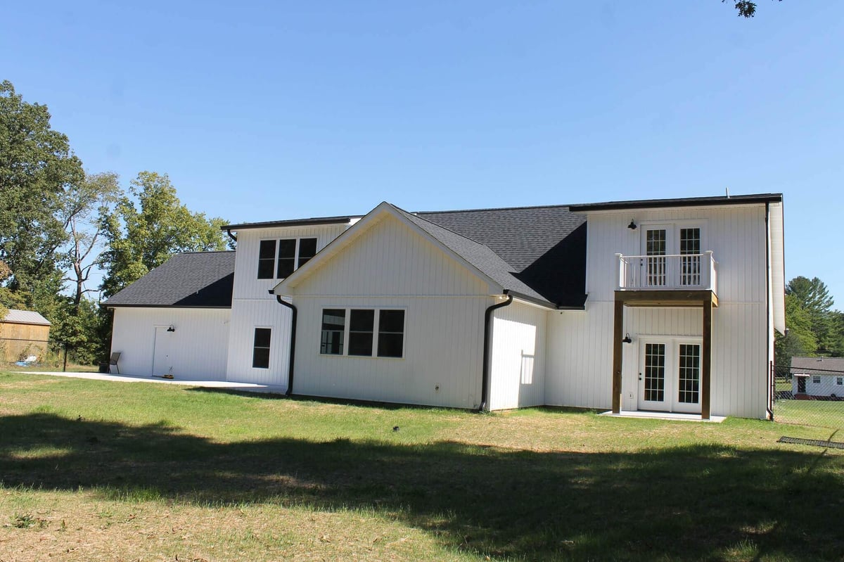 Exterior view of a two-story custom home with white siding by Debuty Builders, Knoxville, TN