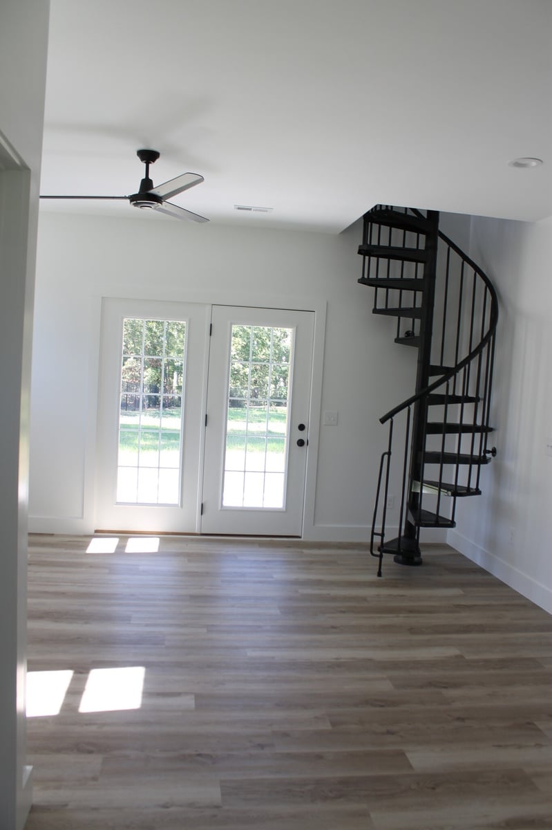Interior space with French doors and spiral staircase in a custom home by Debuty Builders, Knoxville, TN