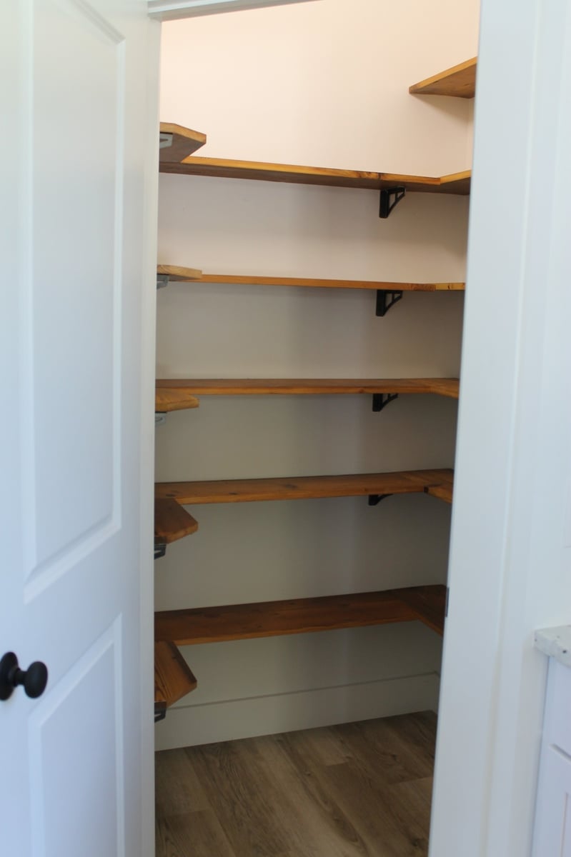 Pantry with wooden shelves in a custom home by Debuty Builders, Knoxville, TN