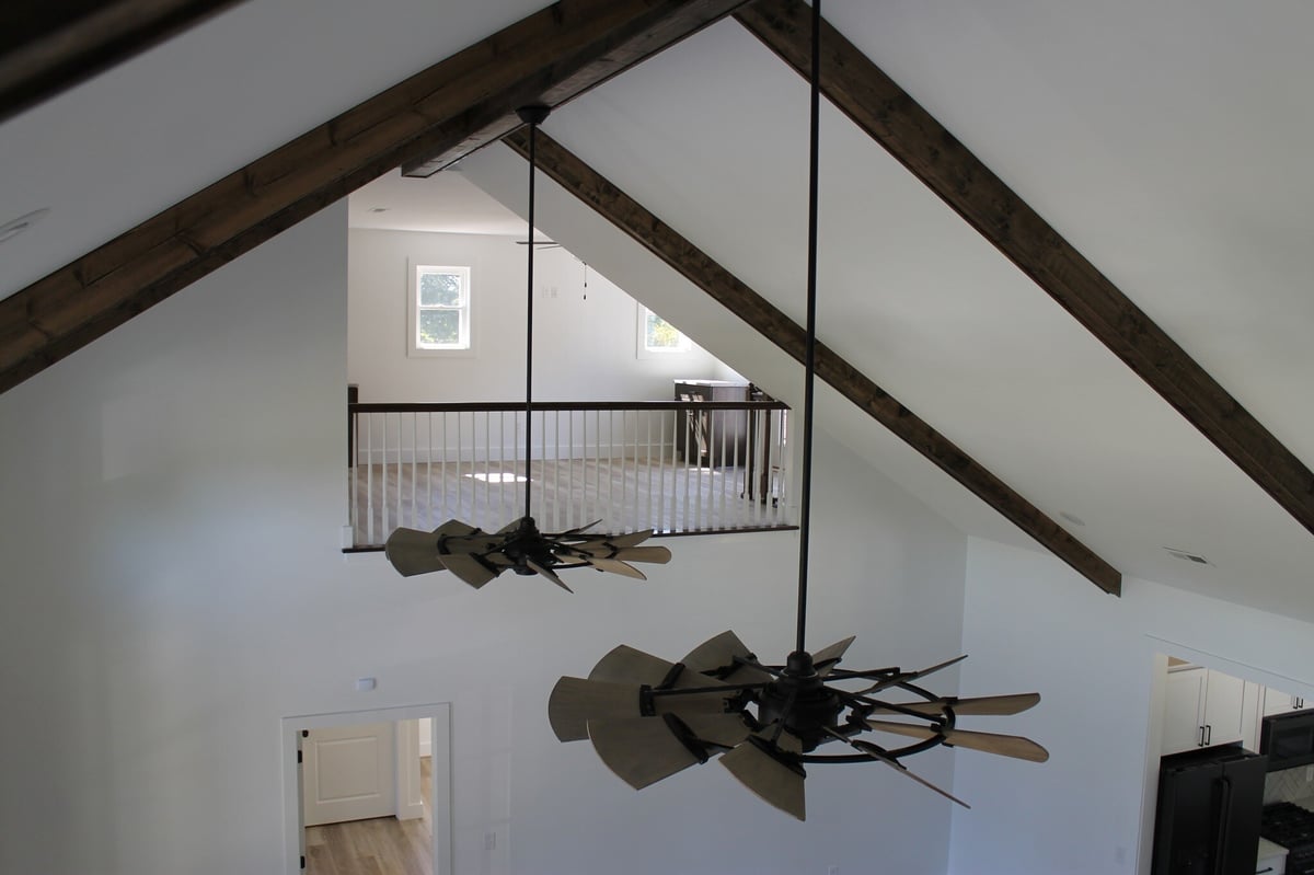 Vaulted ceiling with wood beams and large ceiling fans in a custom home built by Debuty Builders, Knoxville, TN