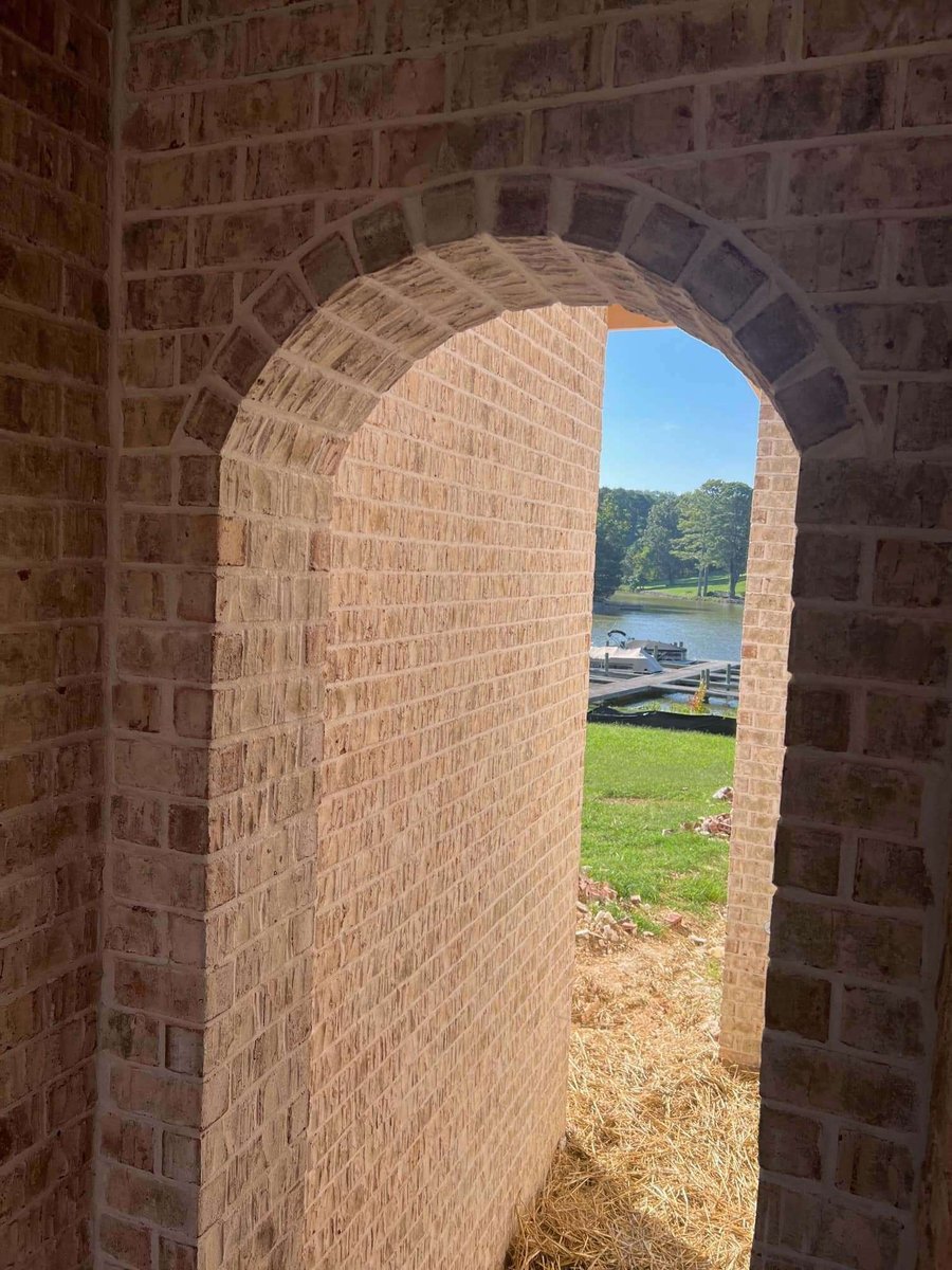 Brick archway leading to a lake view at a custom home in Knoxville, TN by Debuty Builders