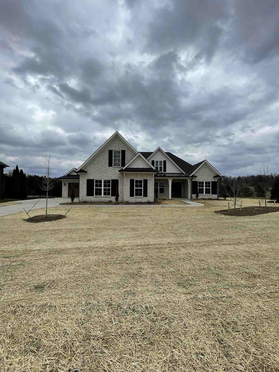 Front view of a custom home with freshly laid straw over the lawn in Knoxville, TN by Debuty Builders