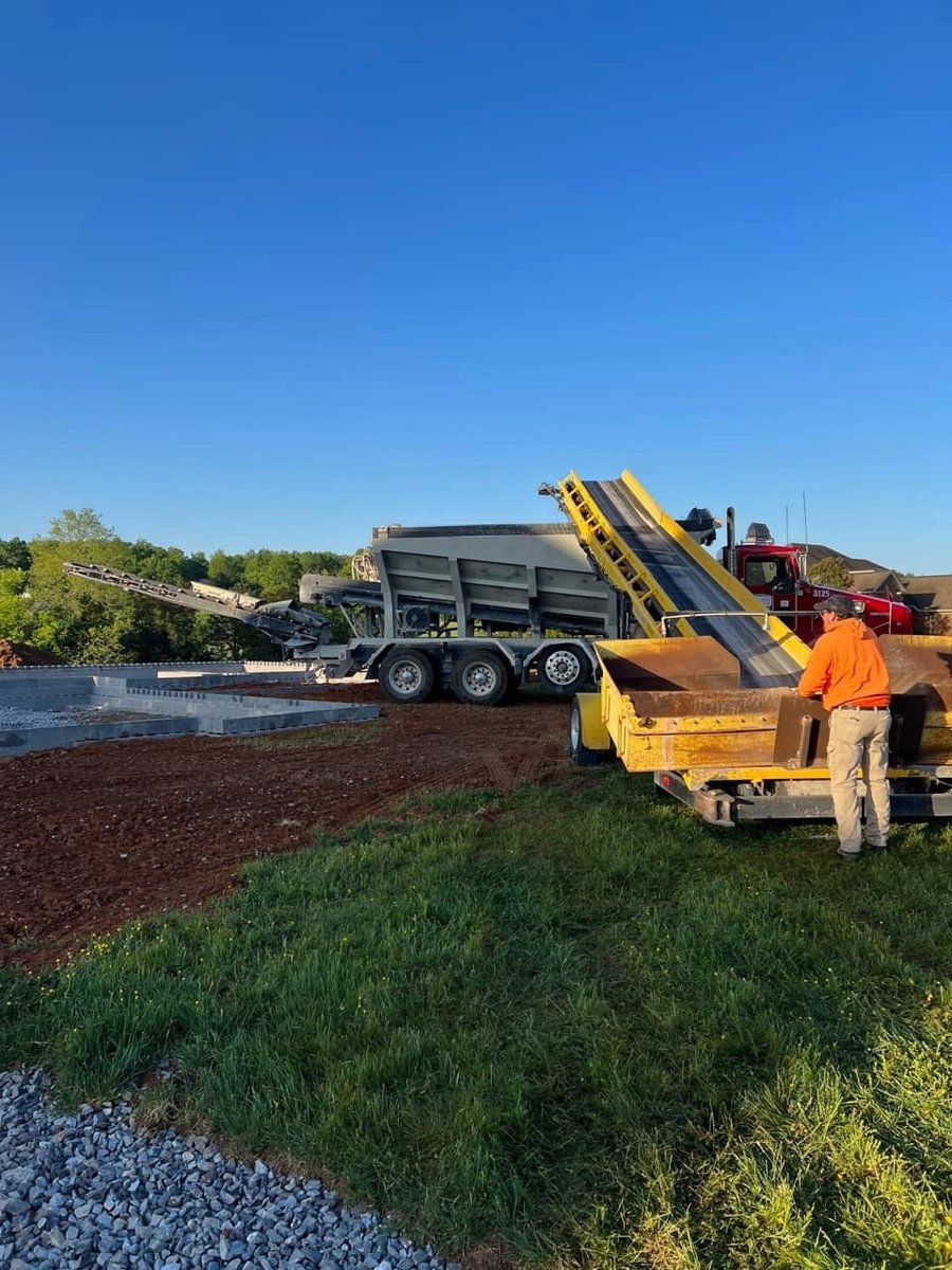 Heavy machinery preparing the foundation at a custom home construction site in Knoxville, TN by Debuty Builders