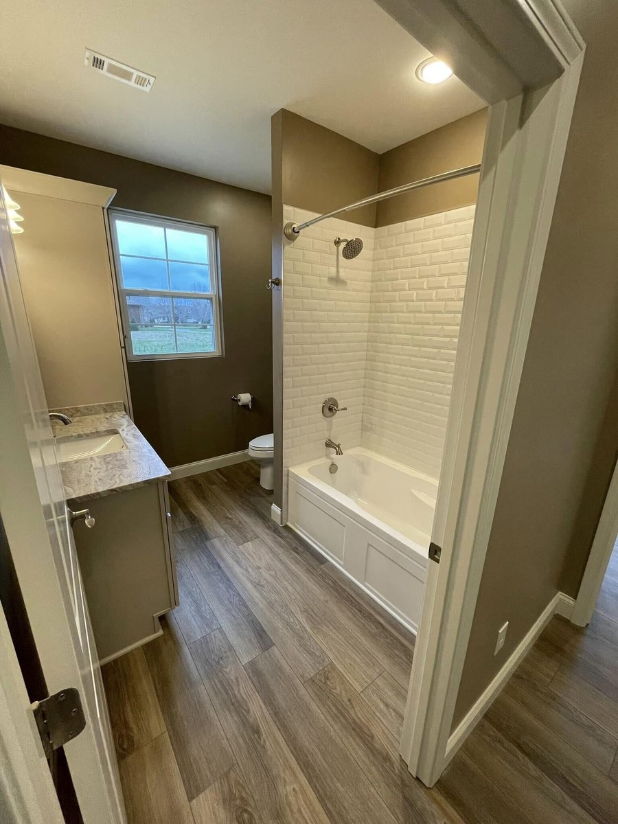 Modern bathroom with a tiled shower and single vanity in Knoxville, TN by Debuty Builders