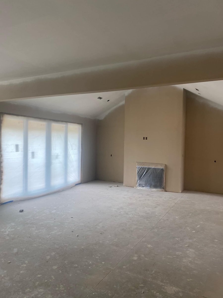 Primed interior walls and large windows in a custom home under construction in Knoxville, TN by Debuty Builders