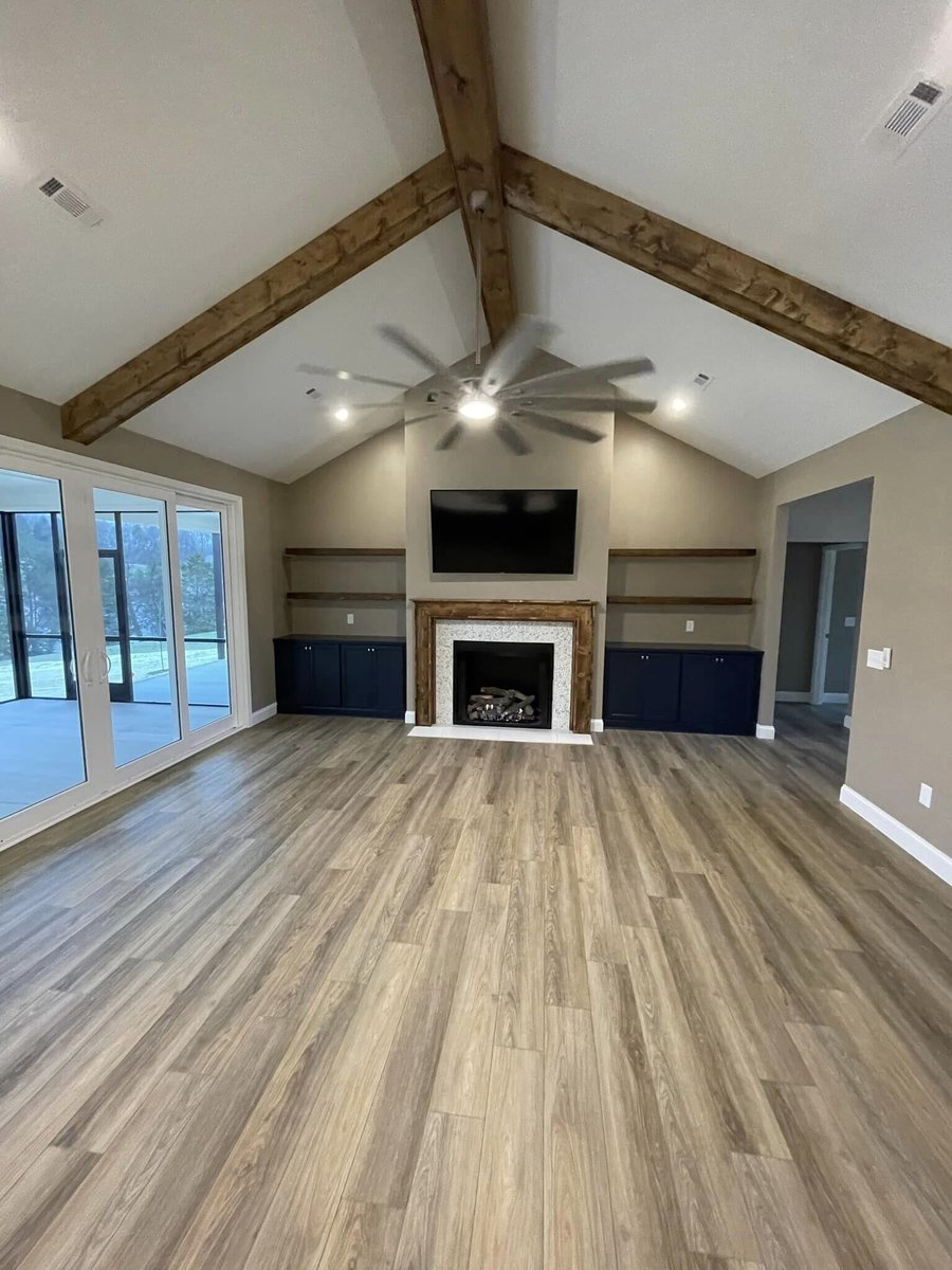 Spacious living room with vaulted ceilings and exposed wood beams in Knoxville, TN by Debuty Builders