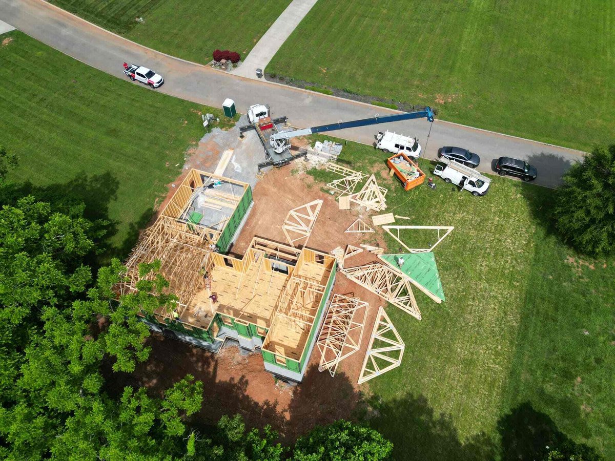 Aerial shot of custom home construction site with roof trusses by Debuty Builders, Knoxville, TN