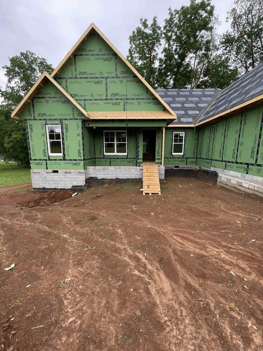 Custom home exterior with green wrap and window installations by Debuty Builders in Knoxville, TN