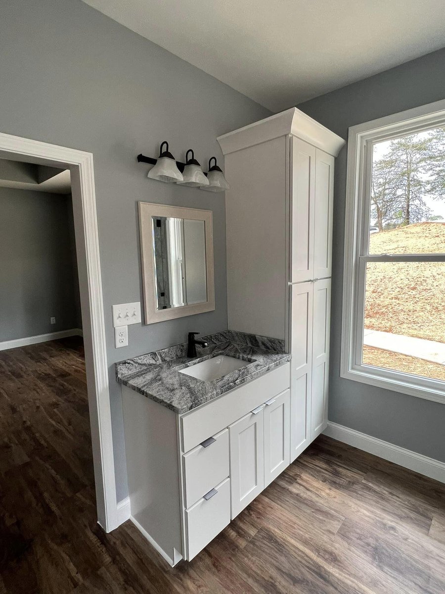 Bathroom vanity with granite countertop and sleek black fixtures, Debuty Builders, Knoxville, TN