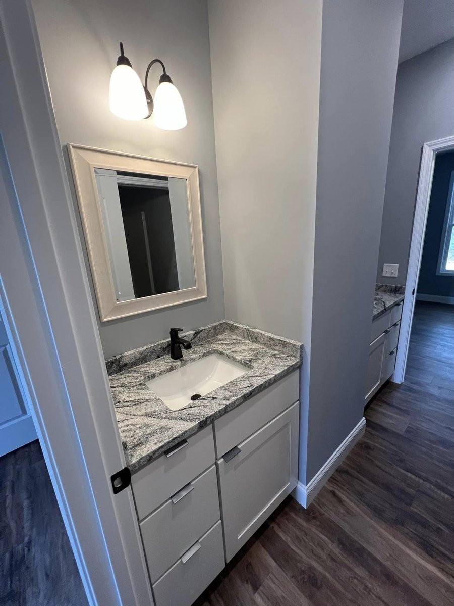 Bright bathroom with granite countertop and classic white cabinetry, Debuty Builders, Knoxville, TN