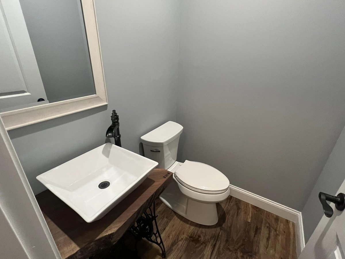 Compact powder room with modern sink and wood-accented vanity, Debuty Builders, Knoxville, TN