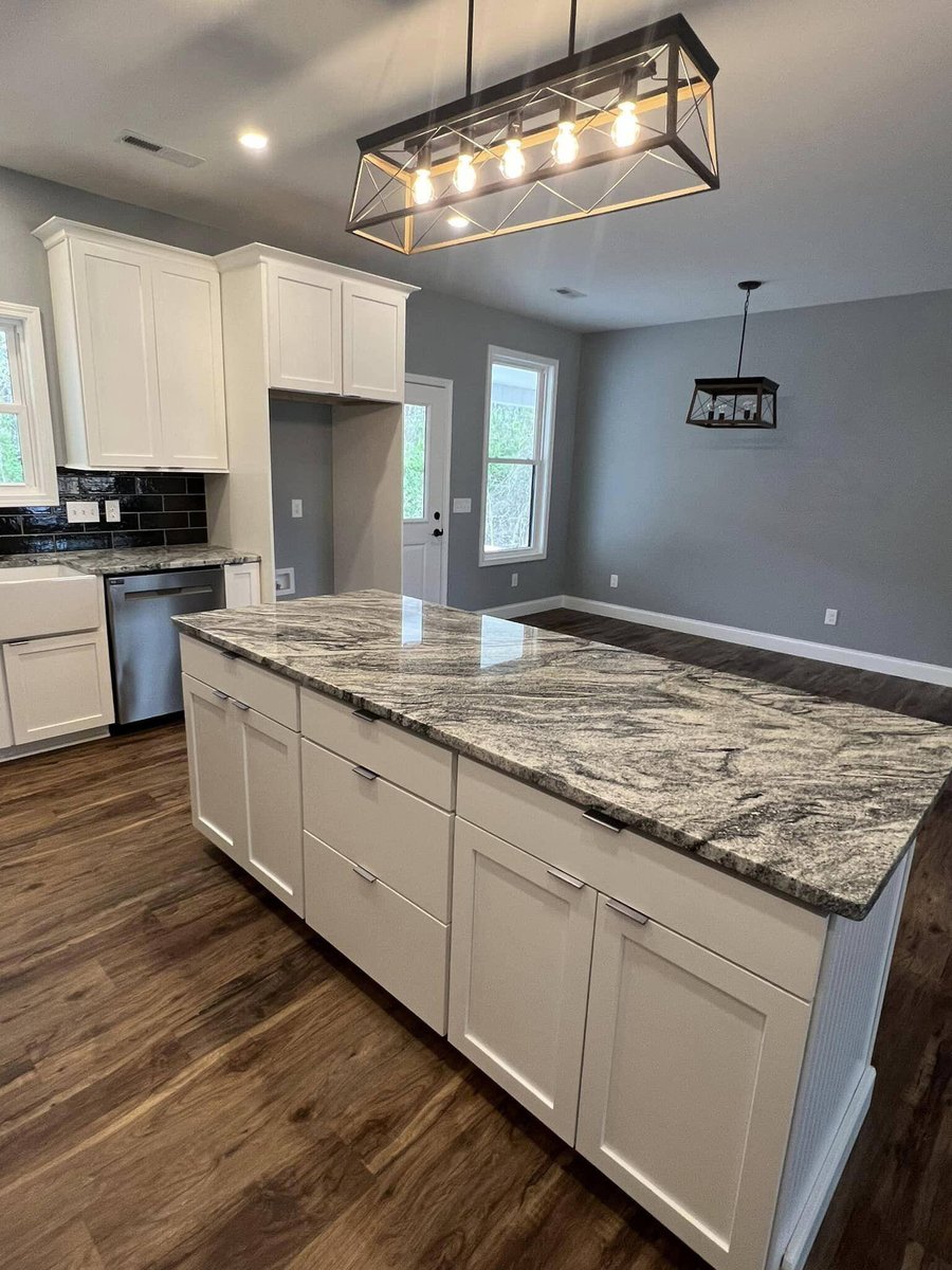 Open kitchen and dining area with large granite island and modern lighting, Debuty Builders, Knoxville, TN