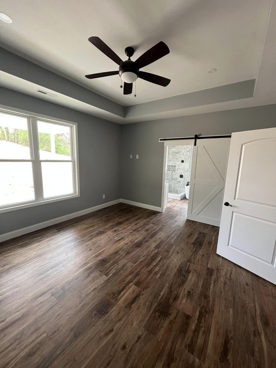Spacious bedroom with ceiling fan and large windows, Debuty Builders, Knoxville, TN