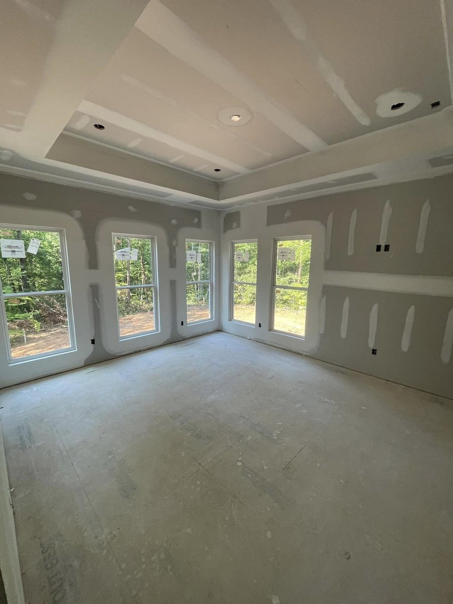 Drywall installation in a custom home with large windows by Debuty Builders in Knoxville, TN