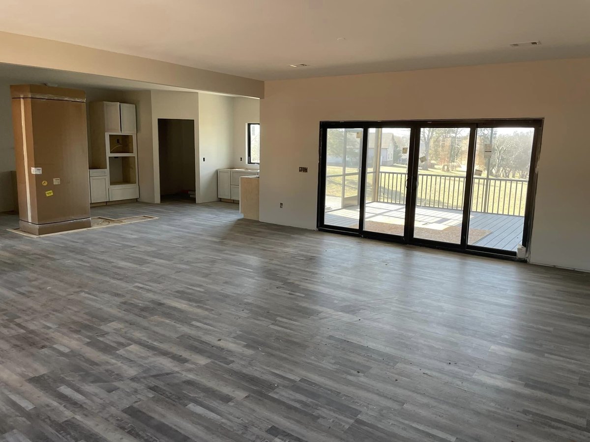 Living room of custom home featuring large sliding doors by Debuty Builders in Knoxville, TN