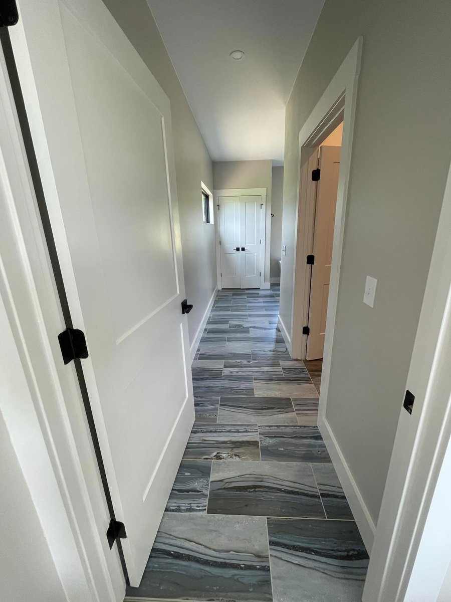 Modern hallway with new flooring in custom home by Debuty Builders in Knoxville, TN