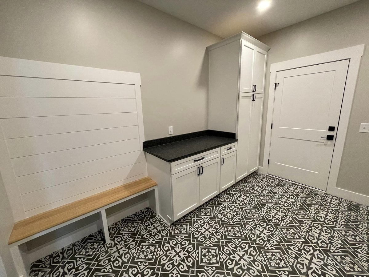 Mudroom with custom bench seating and storage cabinets designed by Debuty Builders in Knoxville, TN