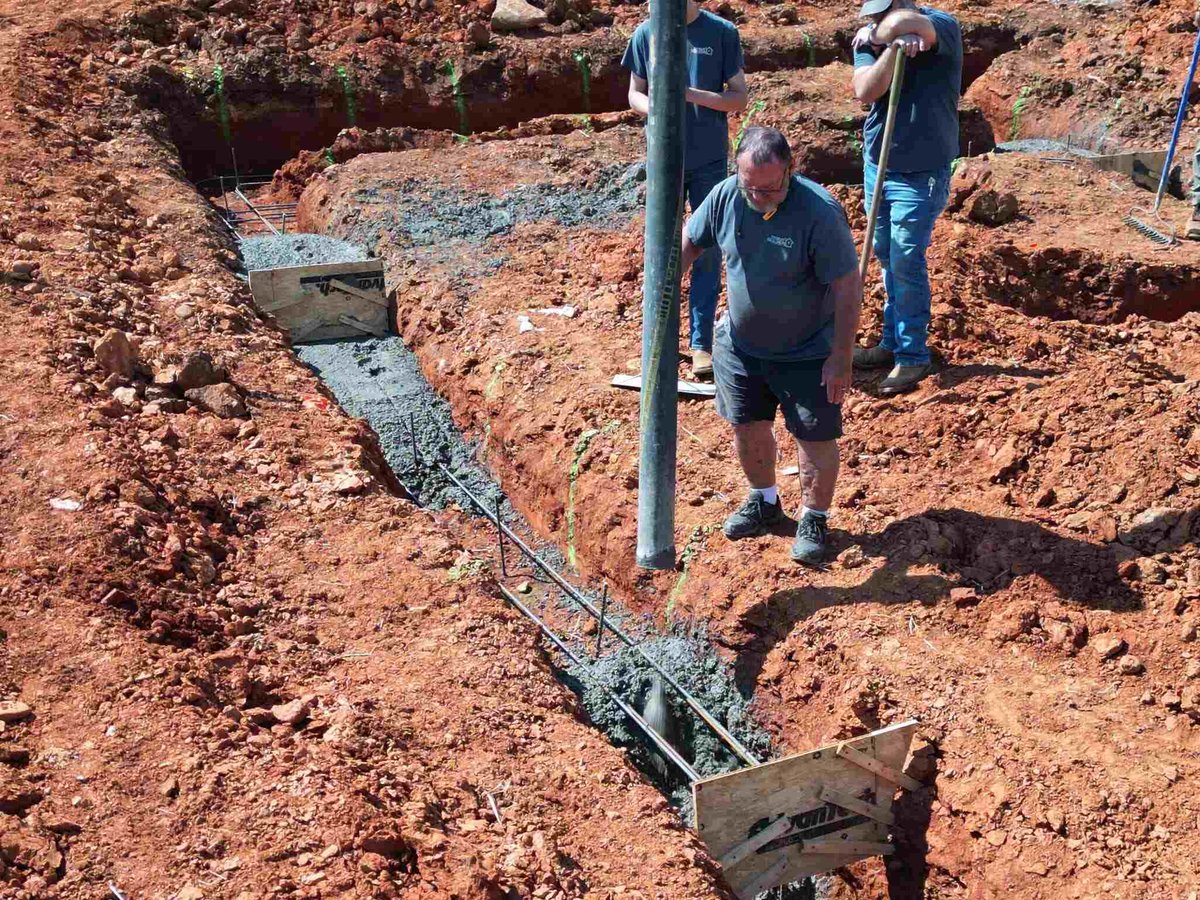 Close-up of concrete being poured into foundation trench, Debuty Builders, Knoxville, TN