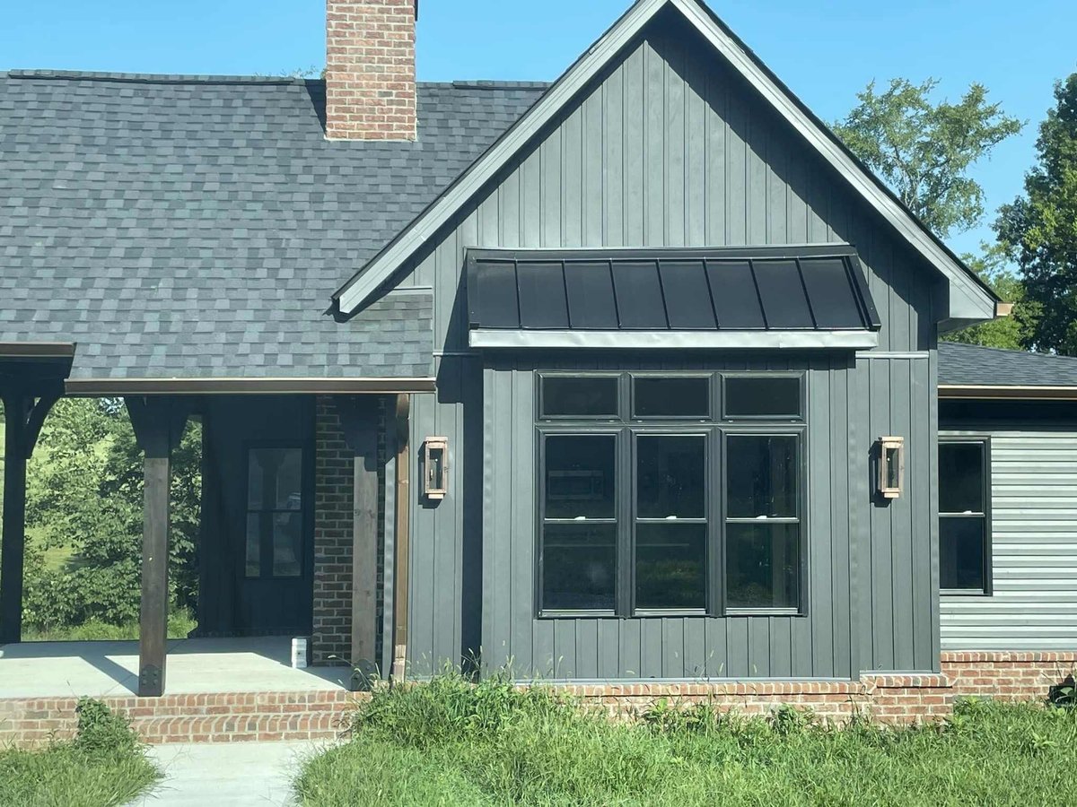 Exterior view of custom home with brick chimney and porch by Debuty Builders, Knoxville, TN