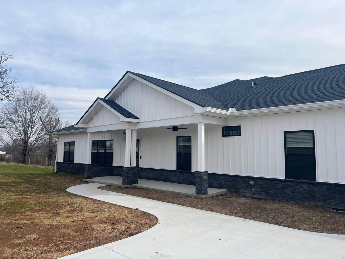 Exterior of a modern farmhouse-style home with white siding by Debuty Builders in Knoxville, TN