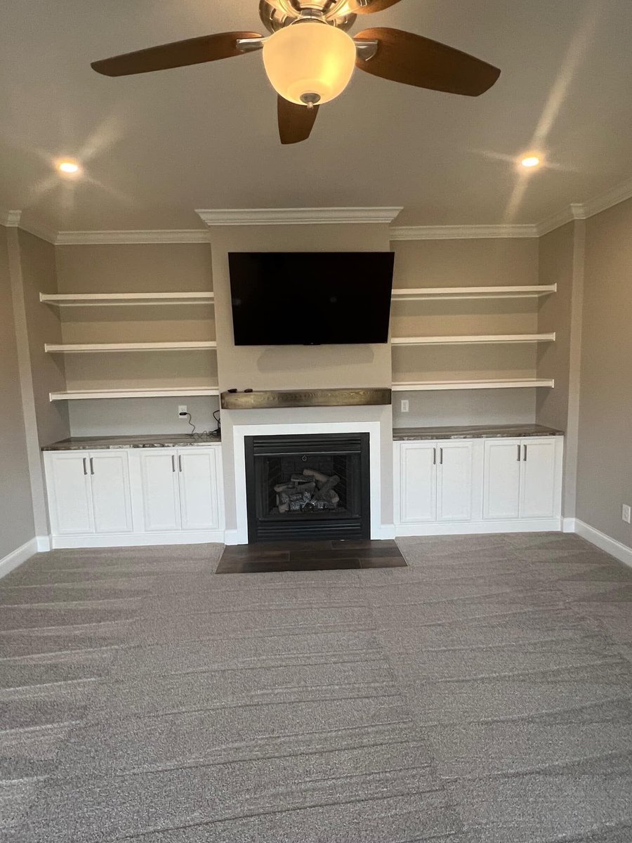 Living room with a built-in fireplace and shelving by Debuty Builders in Knoxville, TN