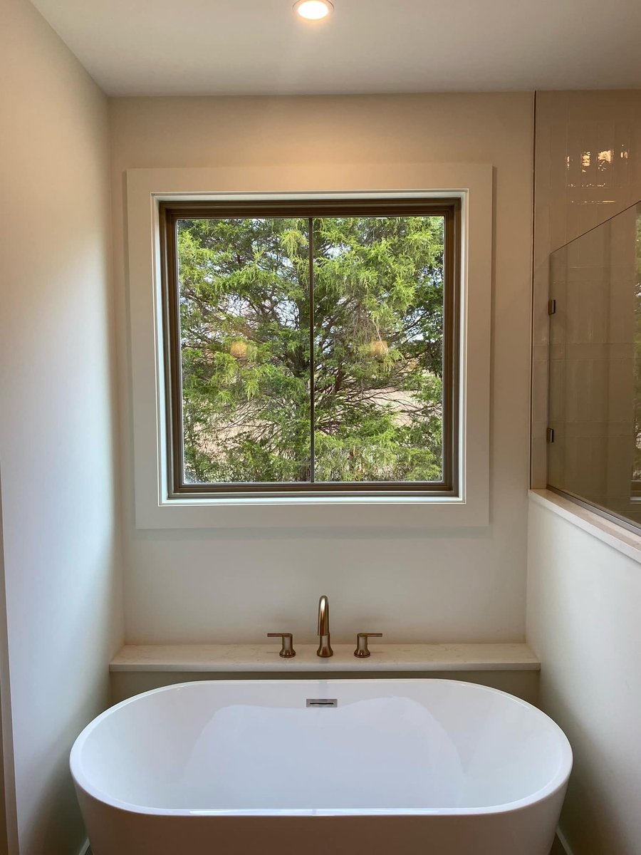 Freestanding bathtub with large window view in a custom home by Debuty Builders, Knoxville, TN
