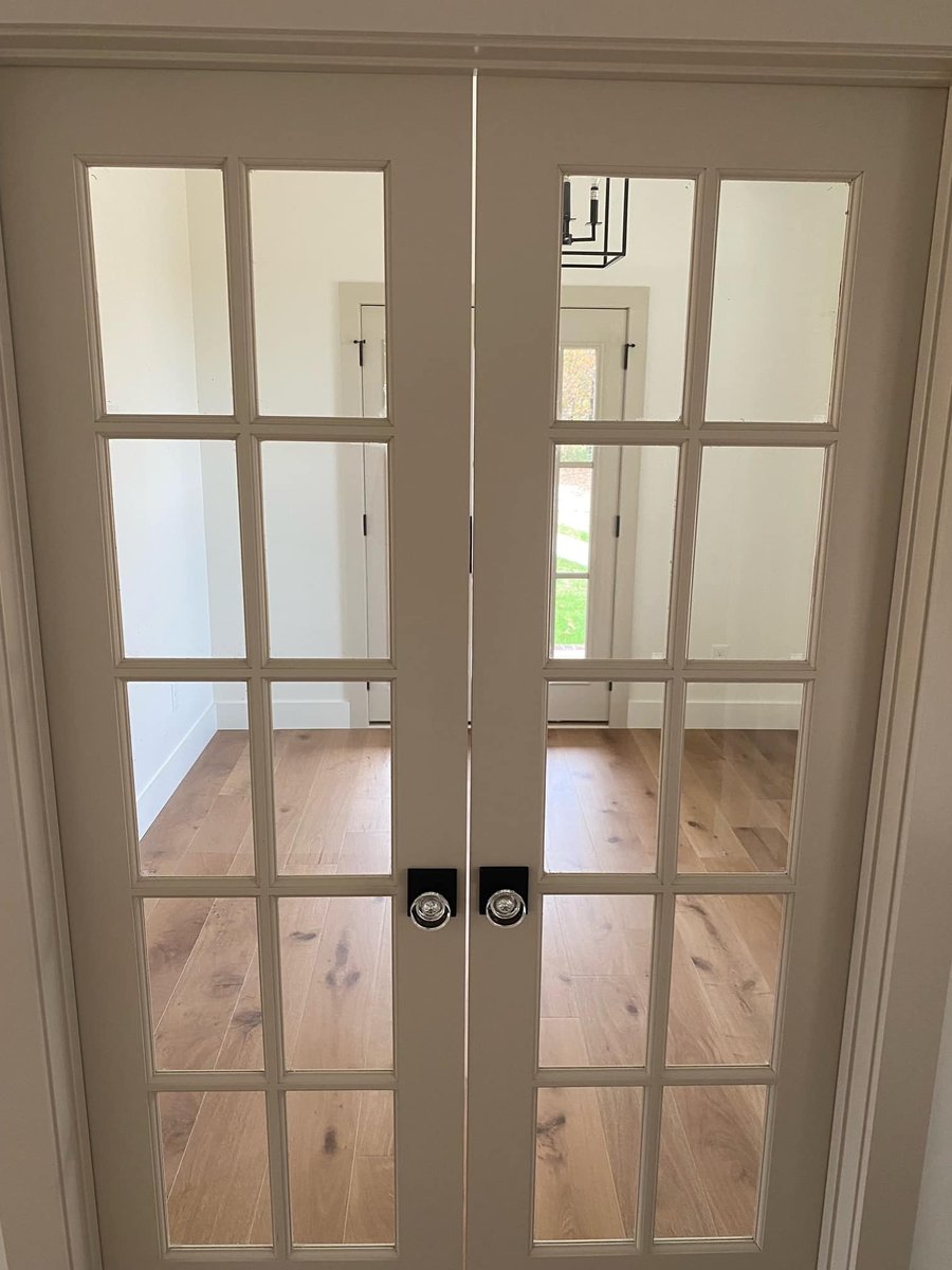 French double doors with glass panels leading to a bright room in a custom home by Debuty Builders, Knoxville, TN