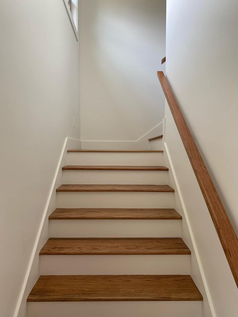 Minimalist wooden staircase in a custom home by Debuty Builders in Knoxville, TN