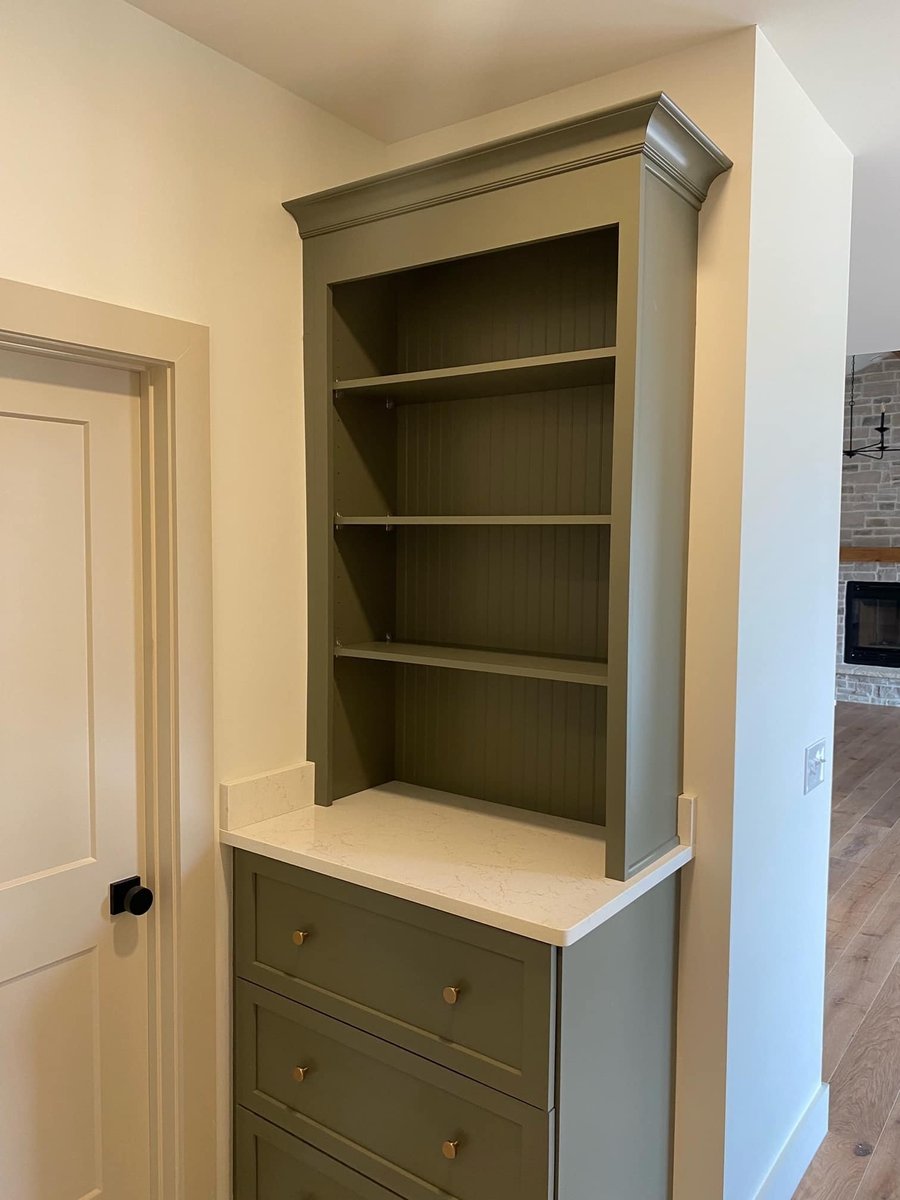 Olive green built-in cabinet with open shelving in a custom home by Debuty Builders in Knoxville, TN