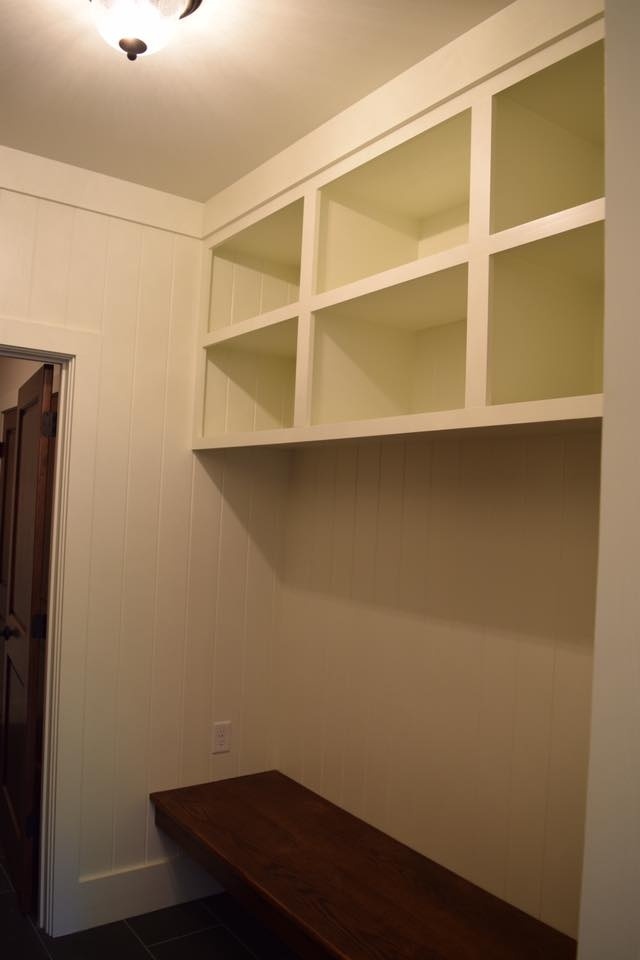 Built-in shelving and seating area in a mudroom designed by Debuty Builders, Knoxville, TN