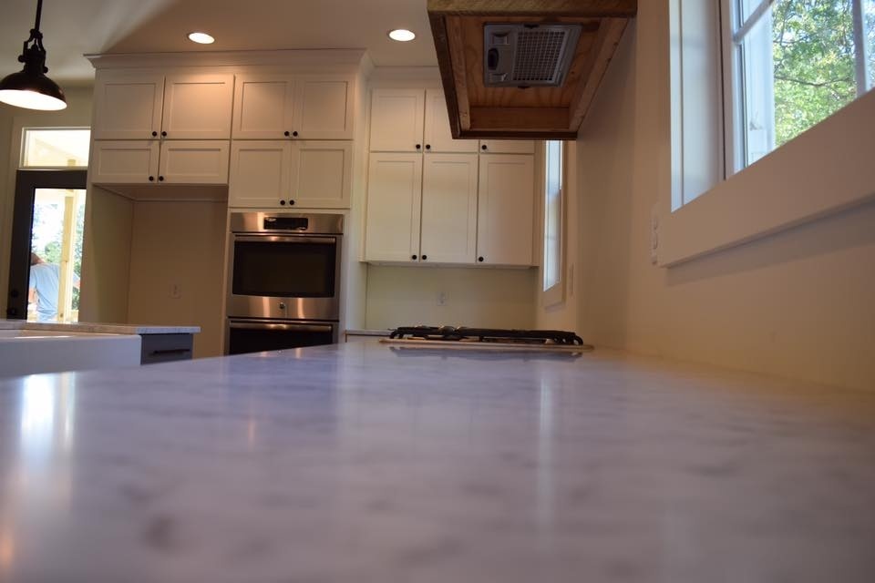 Custom kitchen with marble countertops and white cabinetry by Debuty Builders, Knoxville, TN