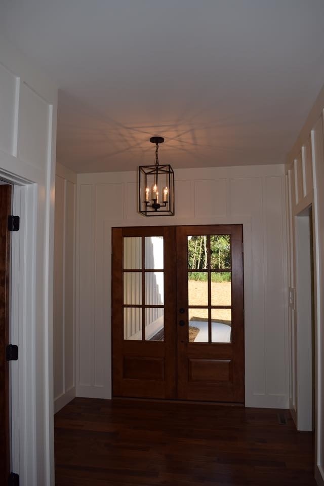 Entryway with wooden double doors in a custom home by Debuty Builders, Knoxville, TN
