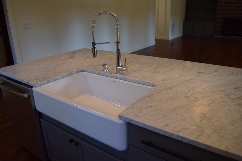 Farmhouse-style kitchen sink with marble countertops in a custom home by Debuty Builders, Knoxville, TN