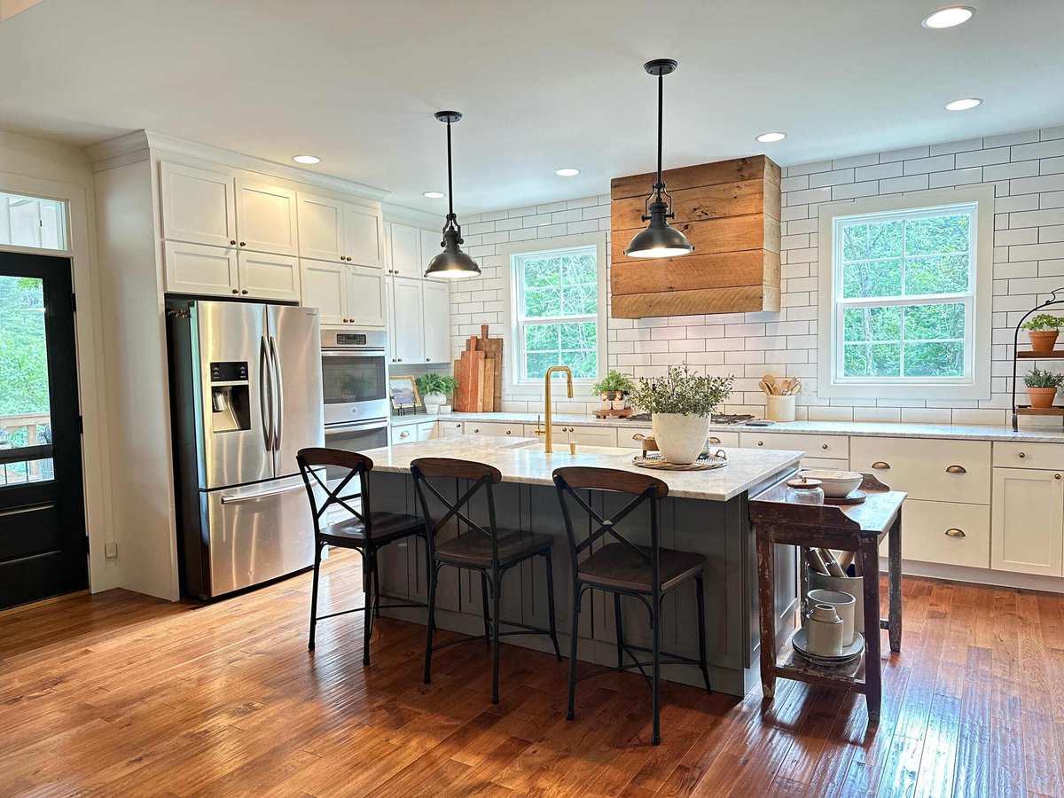 Open concept kitchen with wooden accents and marble countertops by Debuty Builders, Knoxville, TN