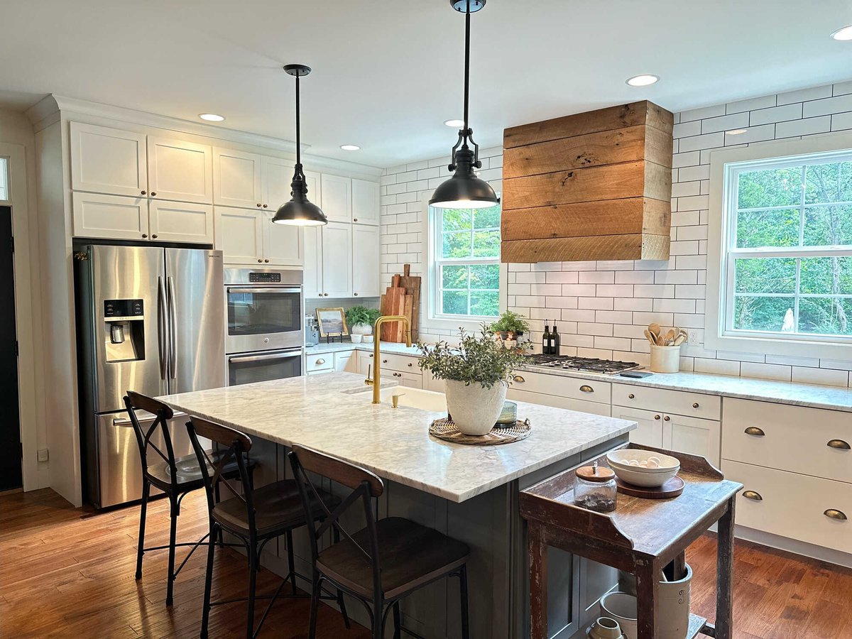 Spacious modern kitchen with white cabinets and subway tile in a custom home by Debuty Builders, Knoxville, TN