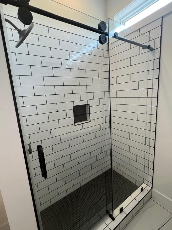 Glass shower enclosure with subway tile design in a custom bathroom by Debuty Builders, Knoxville, TN