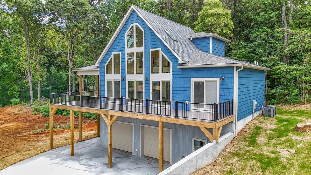 Blue custom-built home exterior with raised deck in Friendsville Custom Home in Knoxville, TN