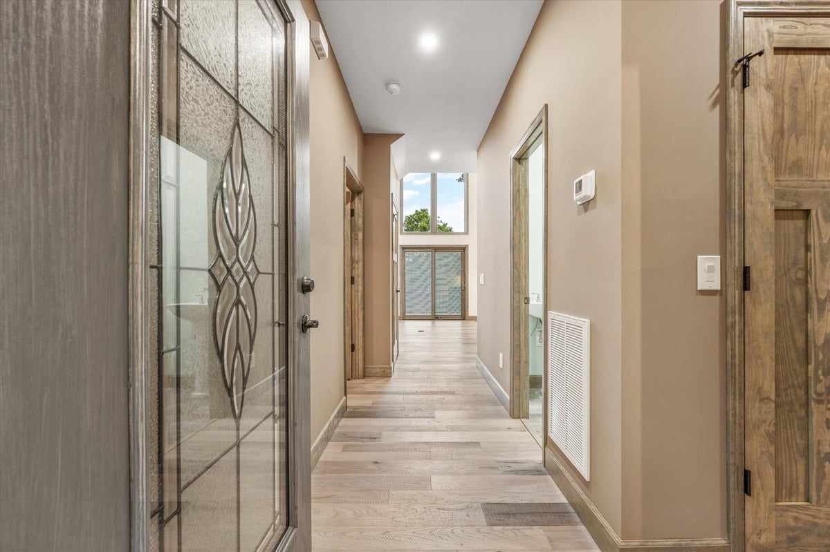 Entry hallway with wood flooring and glass panel door in Friendsville Custom Home in Knoxville, TN